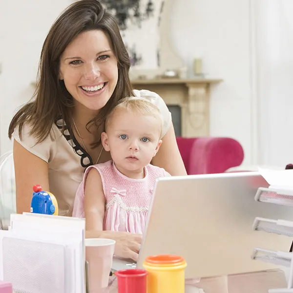 A mother and her young child at home organizing family paperwork
